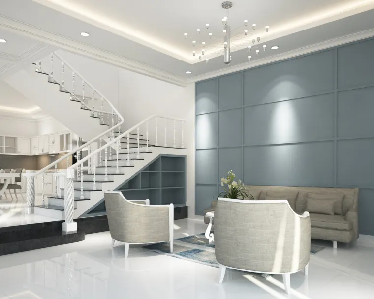 Double-volume stairwell lounge with a panelled wall, sofa and pair of tub chairs