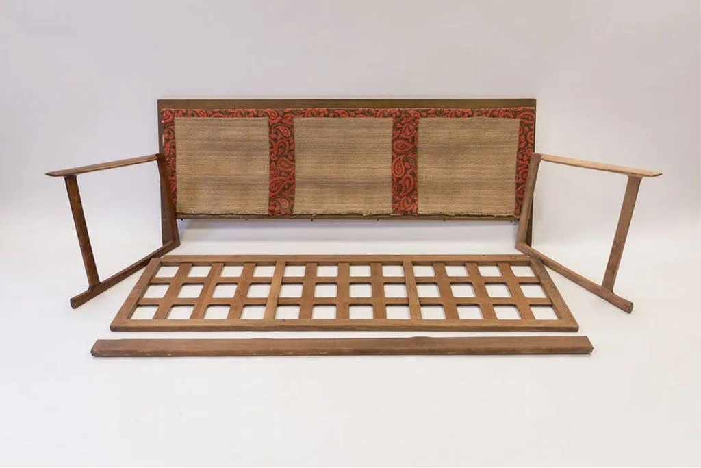 Mid-century sofa stripped back to its bare timber frame with perished webbing